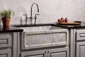 natural stone farm house sink with silver kitchen faucet