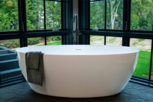 white bathtub with dark silver tub filler
