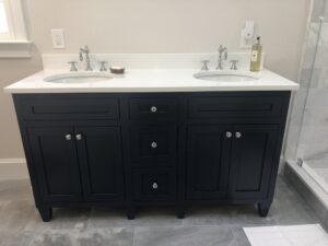 black bathroom vanity with silver hardware and silver bathroom faucets