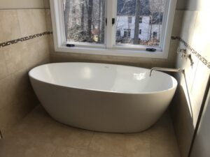 white bathtub with silver bathtub fixtures