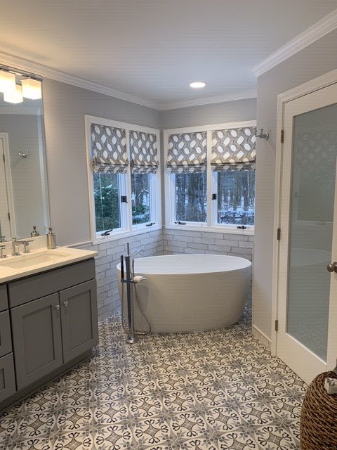 white bathtub with silver fixtures