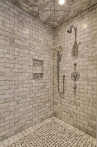 grey shower tile with silver shower fixtures