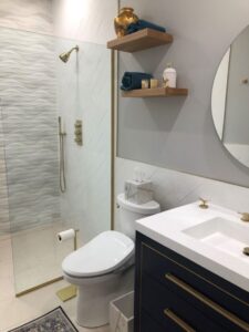 wavy shower white tile, gold shower fixtures