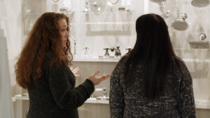 Consultation, sales, saleswoman, people talking, people looking at sink faucet displays,