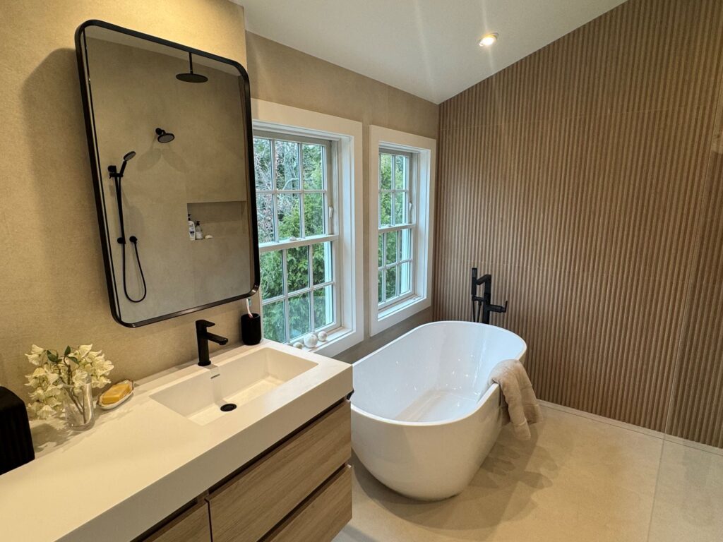 modern bathroom with white freestanding tub and wood accents