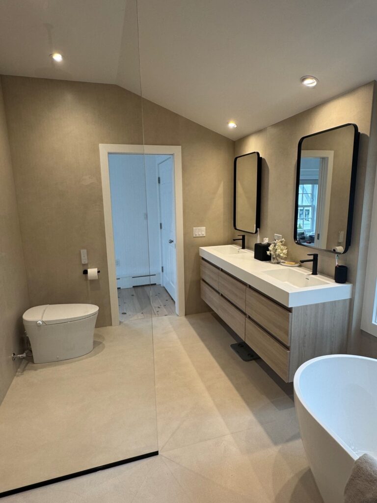 bathroom with floating vanity and freestanding tub