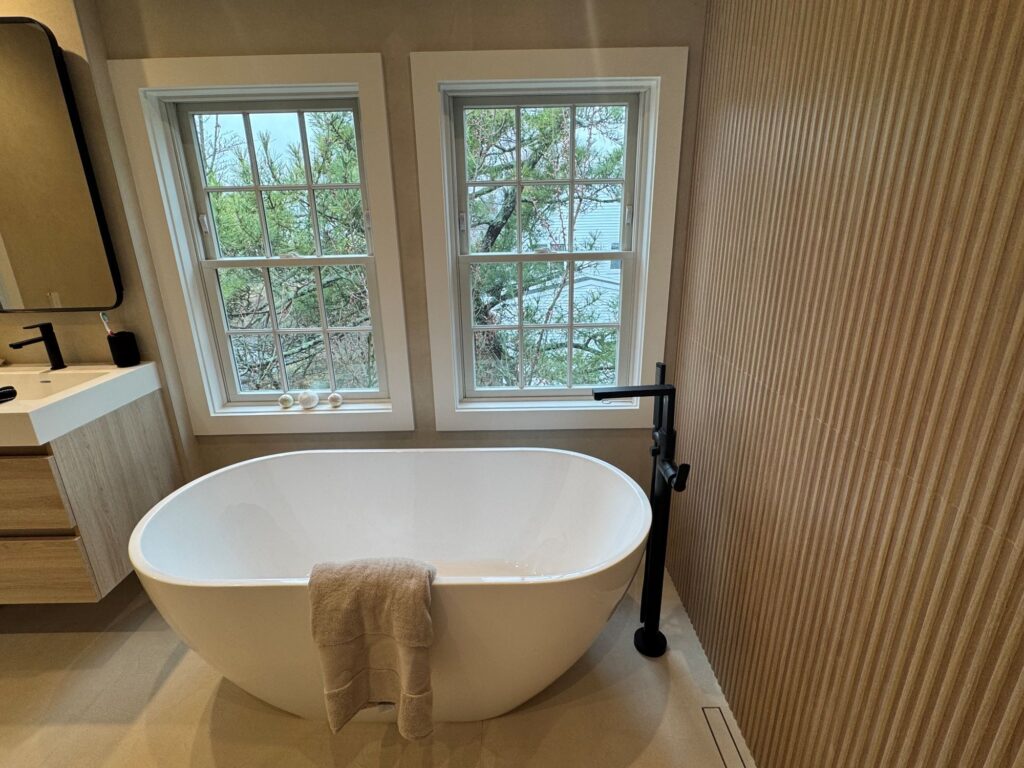 freestanding tub under window