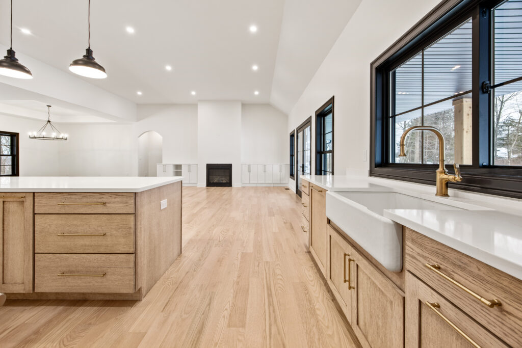 white farmhouse sink and brushed bronze fixtures