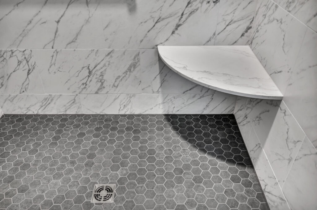 shaving niche in a white and grey tile shower